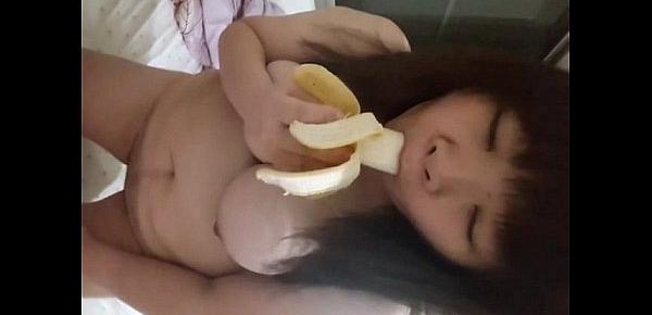  Asian playing with a banana before jamming it in her pussy